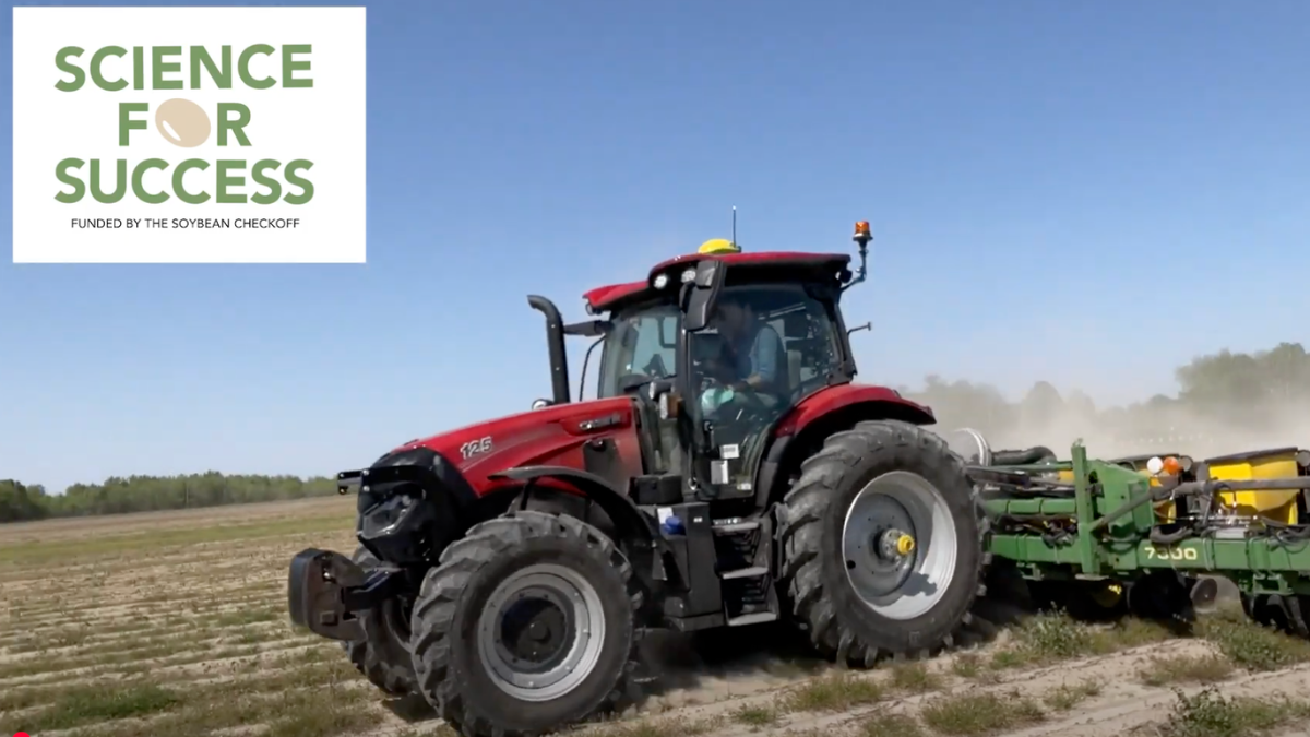 Screenshot of a red tractor pulling a green planter at high speeds in a field.